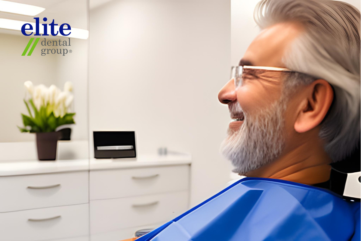 Senior patient with a blue dental bib waiting in a comfortable clinic room dental chair for dentist to check his oral health condition and suitability for All-on-4 dental implants. 