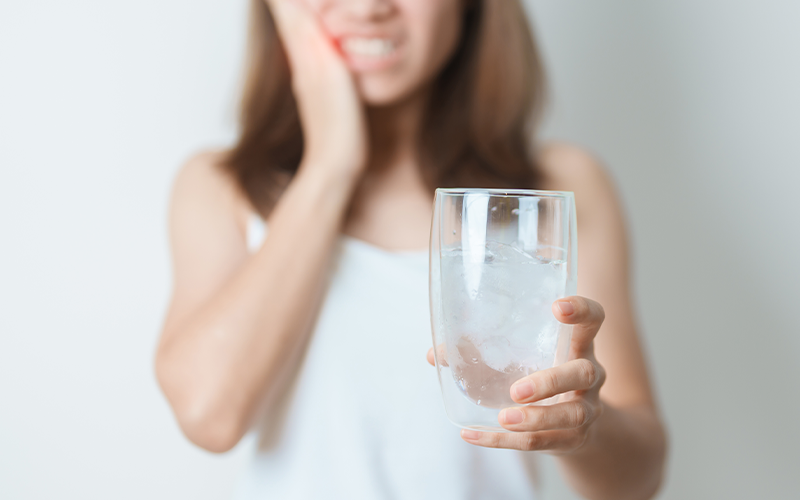 Tooth sensitivity to cold water after a dental filling.